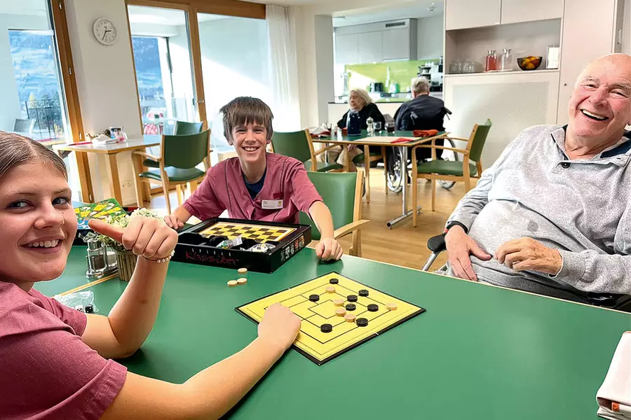 Generationenübergreifende Unterhaltung, die allen Beteiligten Spass macht: Lea und Fabio spielen Nünistei mit dem Bewohnenden Franz Stüssi.